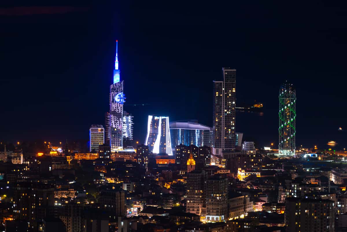 Batumi's skyline at night, its towers lit along the coast.